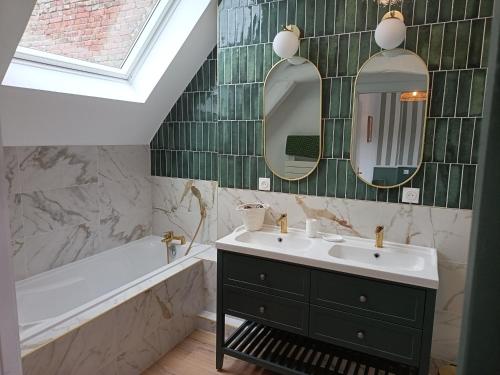 a bathroom with two mirrors and a sink and a tub at L'Abri de Marée Duplex - La Marée Verte" in Saint-Valéry-en-Caux