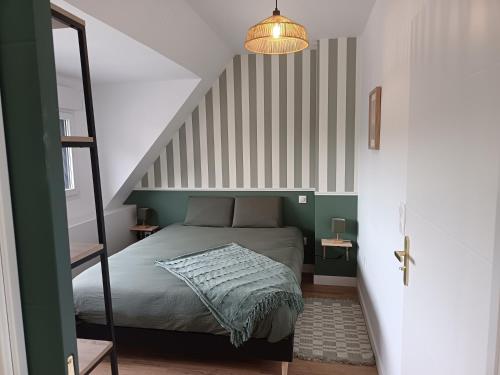 a small bedroom with a bed and a staircase at L'Abri de Marée Duplex - La Marée Verte" in Saint-Valéry-en-Caux