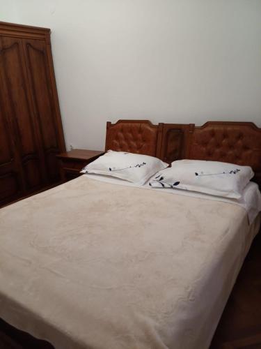 a bed with two white pillows on top of it at Blažo in Neviđane