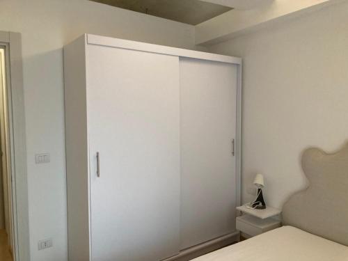 a white closet in a bedroom with a toilet at Casa sulla Piazzetta in Saluzzo