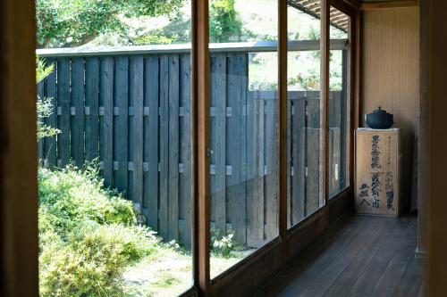 a view of a porch from a window of a house at うだ薬湯の宿やたきや in Uda