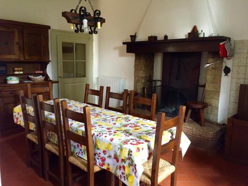 a dining room with a table and a fireplace at Agriturismo Cervano in Toscolano Maderno