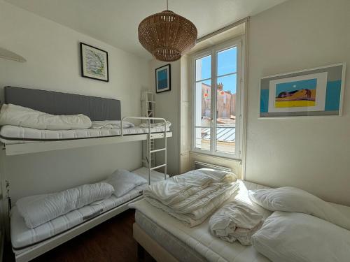 Ένα ή περισσότερα κρεβάτια σε δωμάτιο στο Appartement cosy au centre, à deux pas de la plage, tout équipé pour 4 personnes - FR-1-197-330
