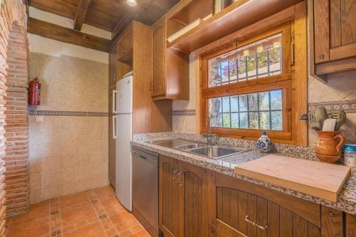 a kitchen with a sink and a refrigerator at Finca El Gales Cortijo Los Olivos in Órgiva