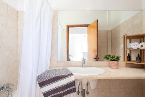 a bathroom with a sink and a mirror at Einalia Holiday Homes near the Beach in (( Elaiónas ))