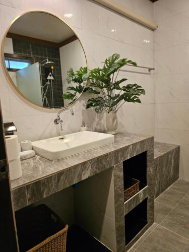 a bathroom with a sink and a mirror at Bang Po Hut in Ban Bang Po