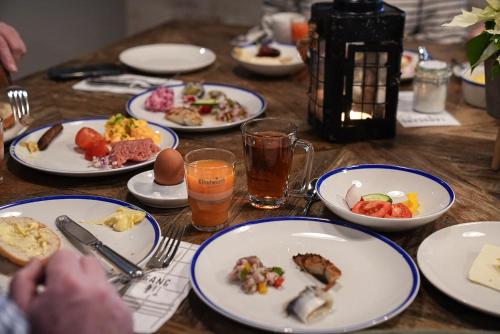 a wooden table with plates of food on it at Lighthouse Hotel & Spa in Büsum