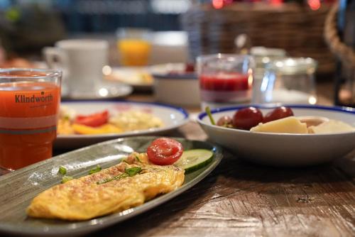 a table with plates of food and a drink at Lighthouse Hotel & Spa in Büsum