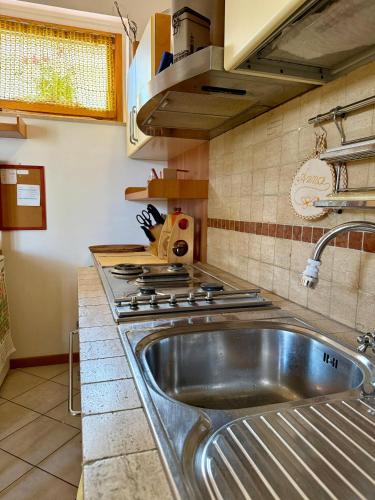 a kitchen with a sink and a stove at Casa di Anna in Senigallia