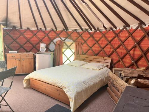 a bedroom with a bed in a yurt at Séjours nature et bien être en YOURTE in La Pesse