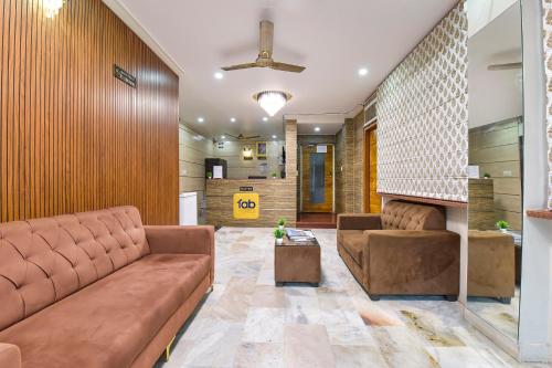 a living room with a couch and a table at FabHotel Silver Stay 04 - Ahinsa circle in Jaipur