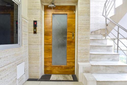 a wooden door on a building with stairs at FabHotel Silver Stay 04 - Ahinsa circle in Jaipur
