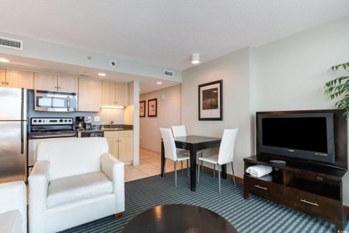 a living room with a kitchen and a dining room at Oceanfront Luxury King Suite at Oceans One Resort in Myrtle Beach