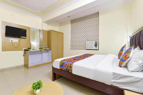 a bedroom with a large bed and a tv at FabHotel Silver Stay 04 - Ahinsa circle in Jaipur