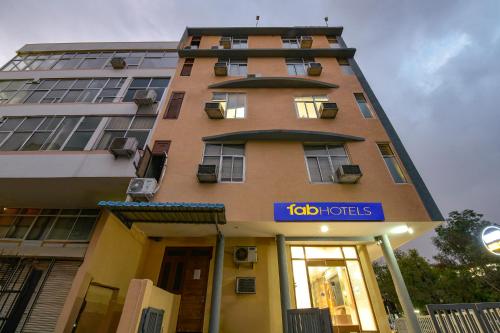 a tall building with a sign in front of it at FabHotel Silver Stay 04 - Ahinsa circle in Jaipur