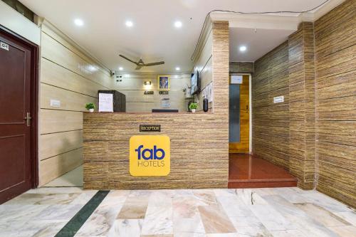 a hotel lobby with a big yellow sign on the wall at FabHotel Silver Stay 04 - Ahinsa circle in Jaipur