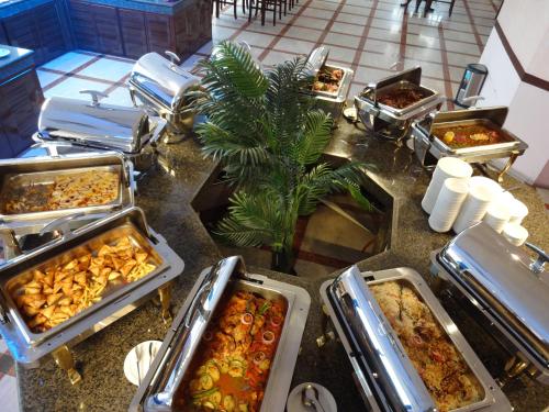 a buffet with many trays of food on a table at Qasr Al Sahab in Khamis Mushayt