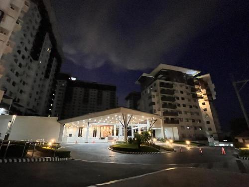 a building with lights in a city at night at The Nook Cabin in Tagaytay