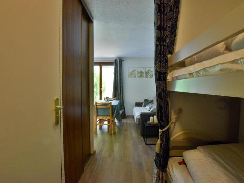 a bedroom with a bunk bed and a living room at Studio cosy à Bernex avec terrasse et parking - FR-1-498-92 in Bernex