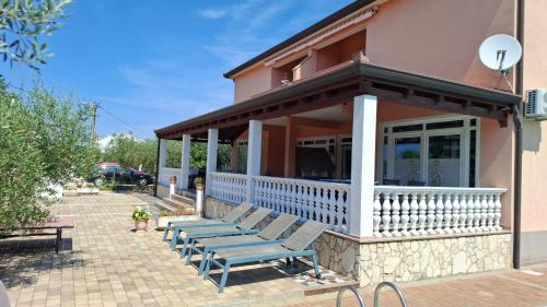 a group of benches sitting outside of a building at Apartments Kimm II in Poreč
