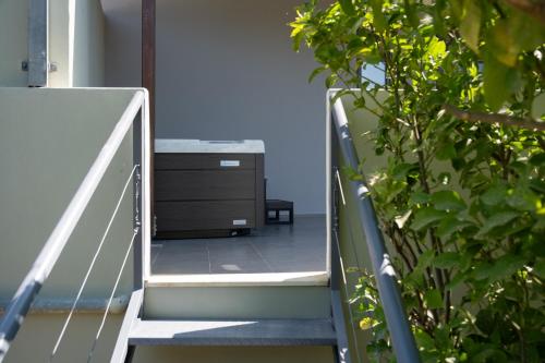 a staircase with a dresser and a cabinet on it at MV Living - Retreat in Daratso