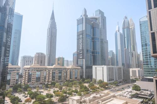 a view of a large city with tall buildings at Modern 1 Bed in Central Park Sleeps 2 with Pool in Dubai