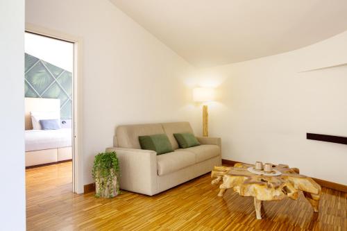 a living room with a couch and a table at Astoria Resort in Riva del Garda