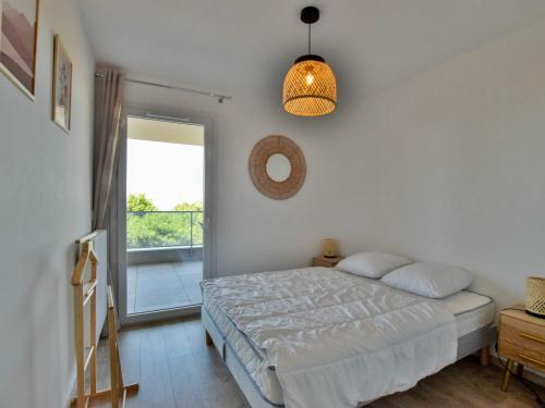 une chambre avec un lit et une grande fenêtre dans l'établissement Appartement neuf moderne avec balcon et garage à Évian - FR-1-498-103, à Évian-les-Bains