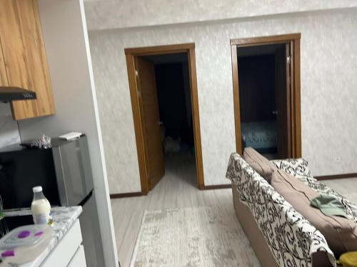 a living room with a couch and two open doors at Апартамент,Новел отель,село Корумду in Korumdy