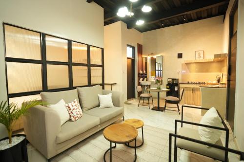 a living room with a couch and a kitchen at The Suites Fourways in Nairobi