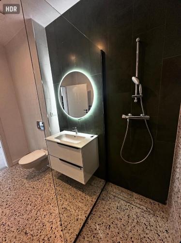 a bathroom with a sink and a mirror at Axxis Luxury Studio in Mamaia