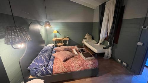 a bedroom with a bed and a table and a lamp at La Collina Dei Castagni in Terni