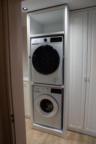 a kitchen with a washer and dryer in a closet at Ionian Blue Apartament 4 in Himare