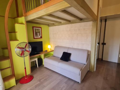 - un salon avec un canapé blanc et un ventilateur dans l'établissement Charmant studio à Sainte-Maxime avec piscine, balcon et parking, proche commerces et plages. - FR-1-780-80, à Sainte-Maxime