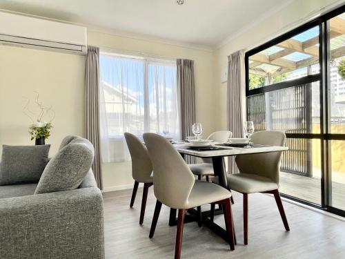 a dining room with a table and chairs at S&N modern 2 bedrooms house opposite Waikato Hospital in Hamilton