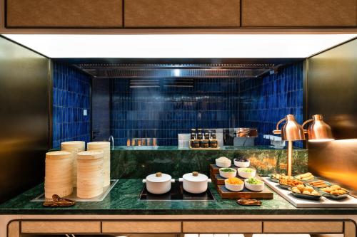 a buffet line with food in a restaurant at Orange crystal Beijing Changying Fudi V Center Hotel in Beijing