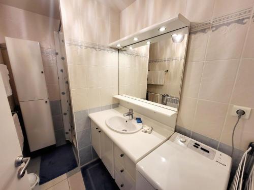 une salle de bain avec un lavabo et un miroir dans l'établissement Appartement 2 pièces face mer avec balcon, parking et WIFI – Les Sables-d’Olonne - FR-1-92-941, à Les Sables-dʼOlonne