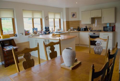 a kitchen with a table with a vase on it at Auchenhill Lodge in Denny