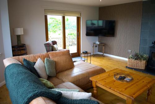 a living room with a couch and a coffee table at Auchenhill Lodge in Denny