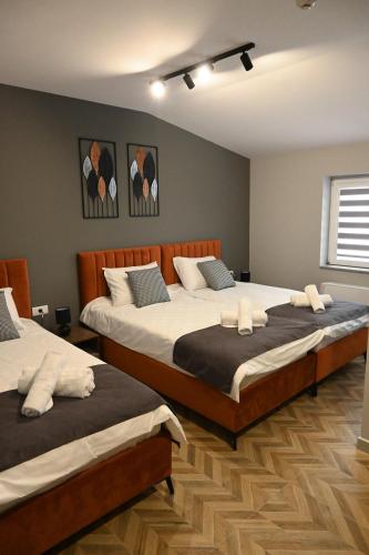 a bedroom with two beds with white pillows at Villa Vista in Bitola