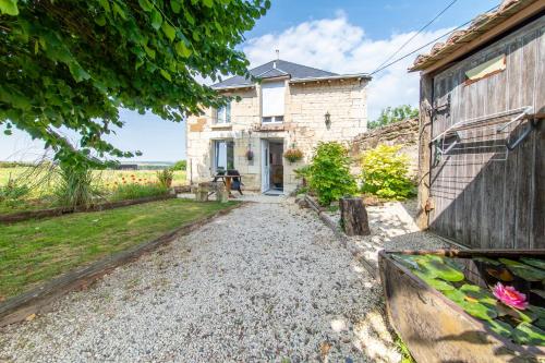 a stone house with a pathway leading to the front door at Lakocoon - Proche Center Parcs in Ranton