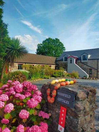 a display of fruit and flowers in a yard at Milking Shed Cottage in Narberth