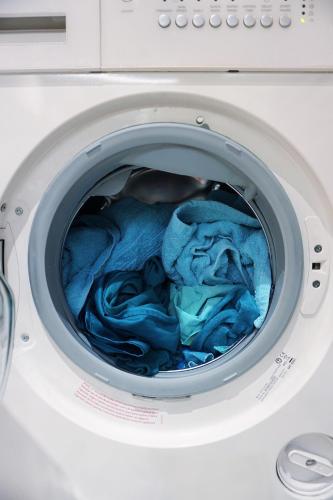 a washing machine with blue cloth inside of it at Relais Motards de Portel in Portel-des-Corbières