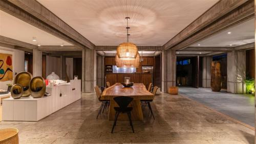 a dining room with a wooden table and chairs at Exceptional Villa close to Lorient Beach in Pointe Milou