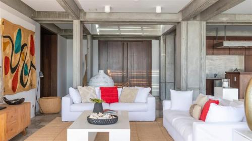 a living room with two white couches and a table at Exceptional Villa close to Lorient Beach in Pointe Milou