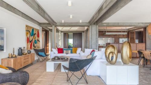 a living room with a white couch and chairs at Exceptional Villa close to Lorient Beach in Pointe Milou