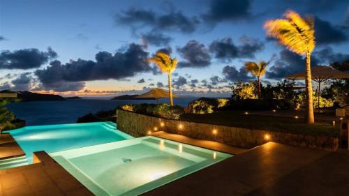 a swimming pool with a view of the ocean at Exceptional Villa close to Lorient Beach in Pointe Milou
