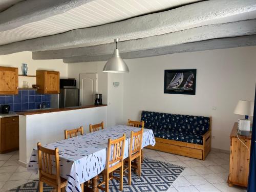 une cuisine et une salle à manger avec une table et des chaises dans l'établissement Maison mitoyenne proche plage, centre Barbâtre, pour 4 personnes - FR-1-823-109, à Barbâtre