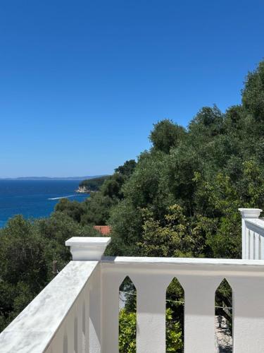 a white balcony with a view of the ocean at Sea Bliss Adults Only in Parga
