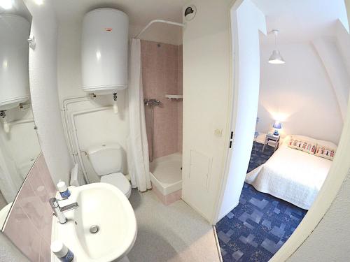 une salle de bain avec un lavabo et des toilettes et un lit dans l'établissement **Charmant T2 à 200m de la plage avec balcon et parking privé à Villers-sur-Mer** - FR-1-712-80, à Villers-sur-Mer